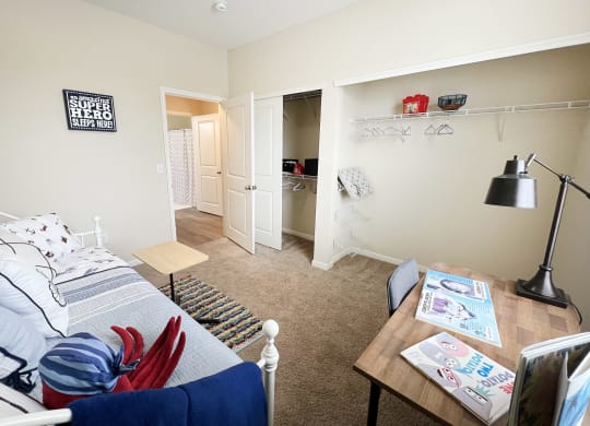 a living room with a couch and a desk and a closet at Residences at Northgate Crossing, Ohio, 43235