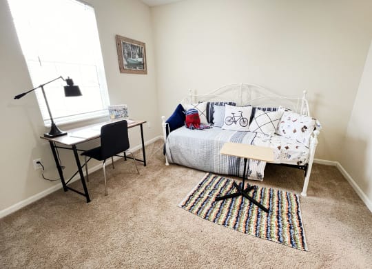 a bedroom with a bed and a desk and a window at Residences at Northgate Crossing, Ohio, 43235