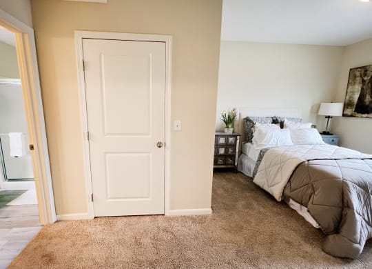 a bedroom with a bed and a closet at Residences at Northgate Crossing, Ohio, 43235