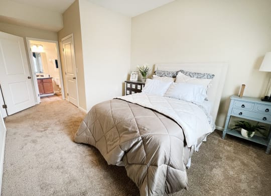 an empty bedroom with a bed and a bathroom at Residences at Northgate Crossing, Ohio, 43235