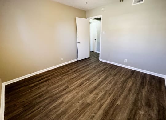 Bedroom with wooden flooring and white interior at Park Place, Richmond