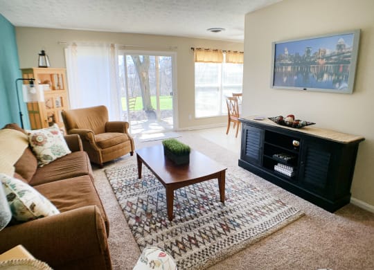 a living room with a couch and a table and a fireplace at Timber Ridge Apartments, Cincinnati, Ohio