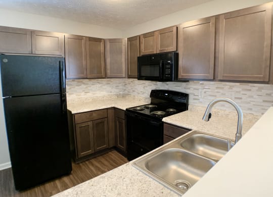 a kitchen with black appliances and granite counter tops  at Aberdine Place, Georgetown, 40324