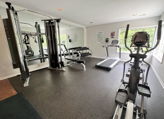 a gym with exercise equipment on the floor and a window at The Vinings Apartments, Cincinnati, Ohio
