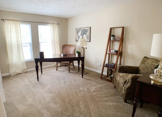 a living room with a desk and a couch  at Knobs Pointe Apartments, New Albany, IN, 47150