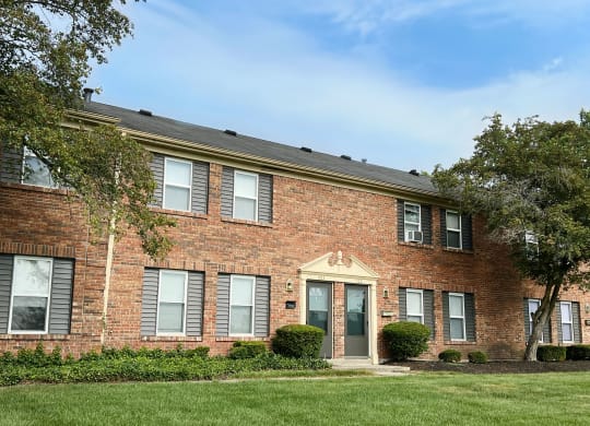 our apartments are located in a brick building with green grass and trees at Revere Village Apartments, Centerville