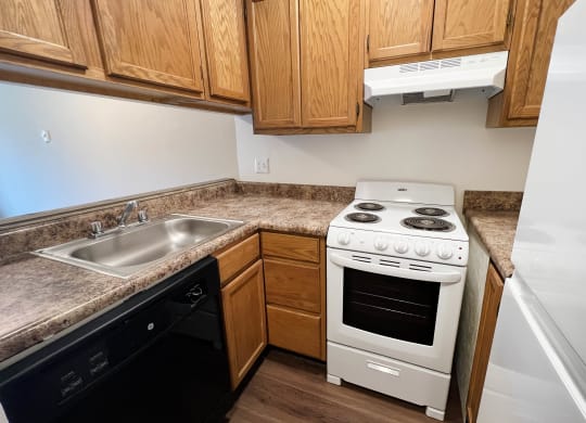 Kitchen With White Cabinetry And Appliances  at Concord Woods Apartments, Ohio