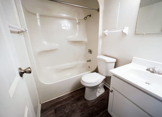 a bathroom with a white sink and toilet next to a white bathtub at Indian Lookout Apartments, Cincinnati