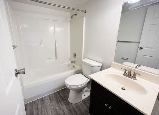a bathroom with a bathtub toilet and sink at Quail Meadow Apartments, Cincinnati, OH