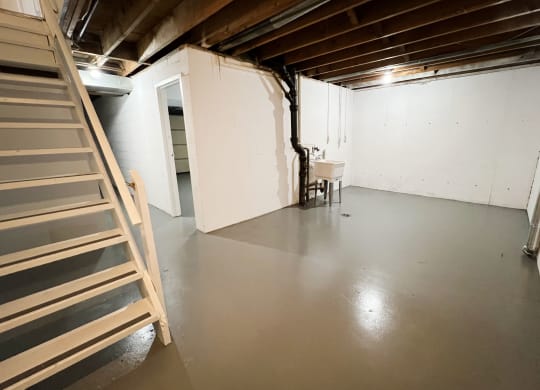 a large room with white walls and a gray floor