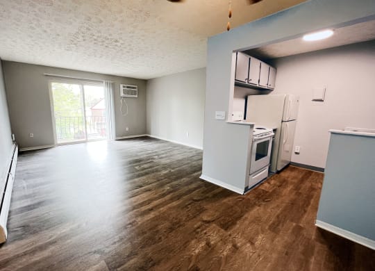 a kitchen and living room in an apartment  at Summit East - A Senior Community, Cincinnati, OH, 45237