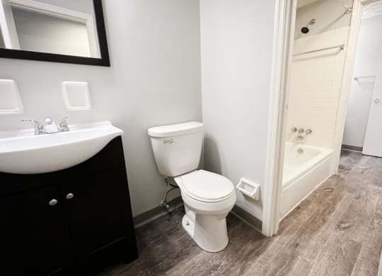 a bathroom with a toilet sink and bathtub  at Summit East - A Senior Community, Ohio, 45237