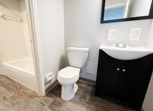 a bathroom with a toilet sink and bathtub  at Summit East - A Senior Community, Cincinnati