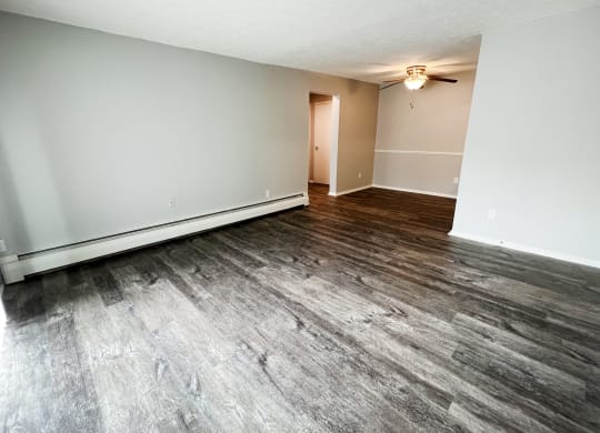 an empty living room with a ceiling fan  at Summit East - A Senior Community, Cincinnati, Ohio