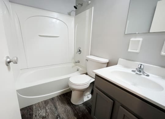 a bathroom with a toilet sink and bathtub  at Summit East - A Senior Community, Ohio, 45237