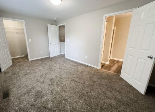 a bedroom with two closets and a door to a bathroom  at Woodhills Apartments, Ohio