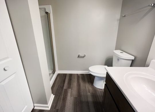 a bathroom with a toilet sink and shower  at Woodhills Apartments, Ohio, 45449