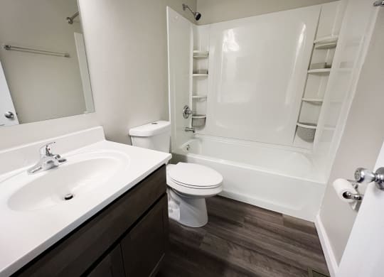 a bathroom with a sink toilet and bathtub  at Woodhills Apartments, West Carrollton, 45449