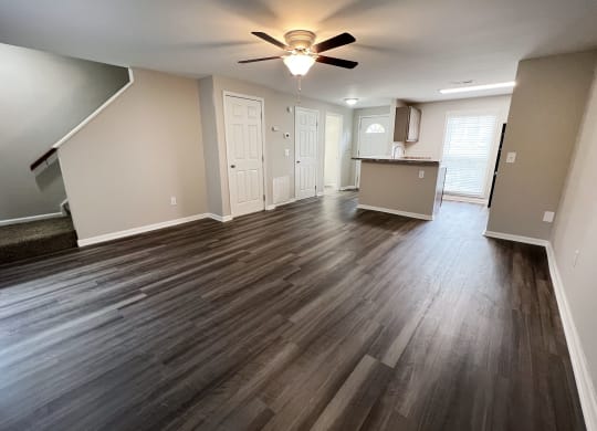 a photo of a living room with hardwood floors and a ceiling fan  at Woodhills Apartments, West Carrollton, OH