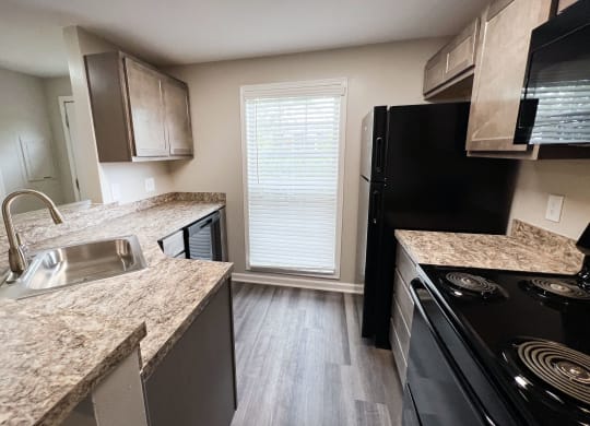 a kitchen at the acadia park apartments in houma, la  at Woodhills Apartments, West Carrollton, OH, 45449