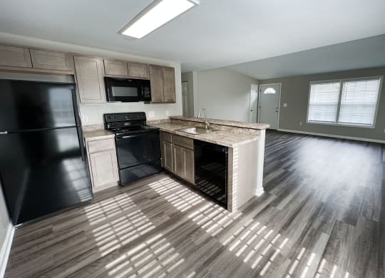 an open floor plan with a kitchen and living room  at Woodhills Apartments, West Carrollton, 45449