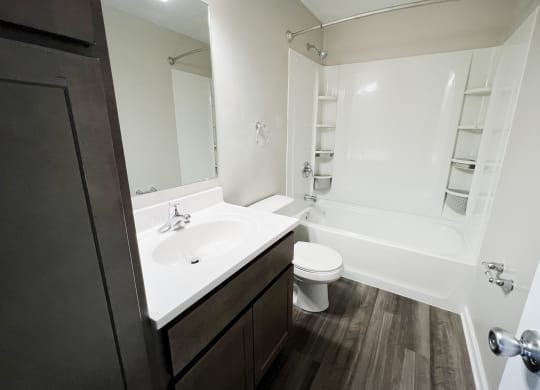 a bathroom with a sink toilet and bathtub  at Woodhills Apartments, West Carrollton, 45449