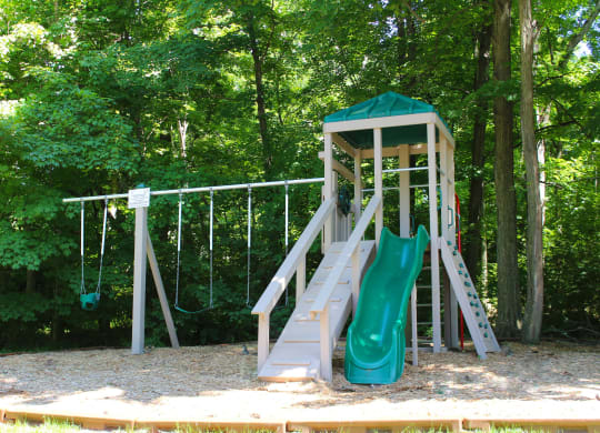 a playground with a slide and a swing set at The Vinings Apartments, Cincinnati, 45245