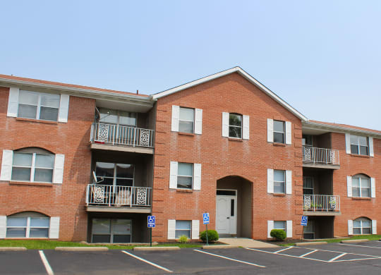 a brick apartment building with balconies and a white door  at Four Worlds Apartments, Ohio, 45231