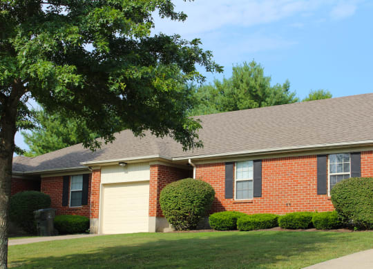 a brick house with a tree in front of it  at Aberdine Place, Georgetown, KY