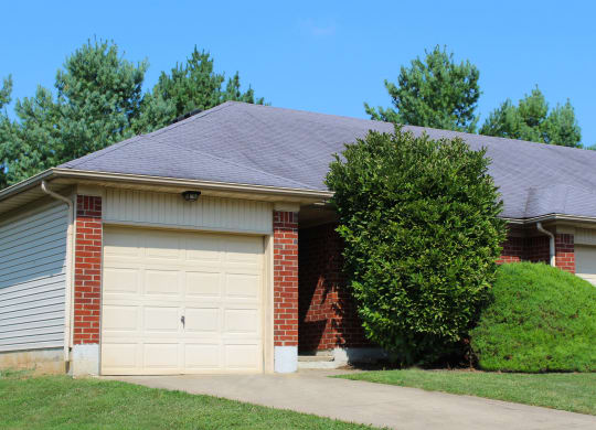 a brick house with a white garage door  at Aberdine Place, Georgetown, KY, 40324