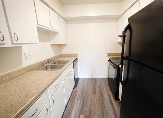 a kitchen with white cabinets and black appliances  at Hunter's Creek Apartments, Cincinnati, OH, 45242