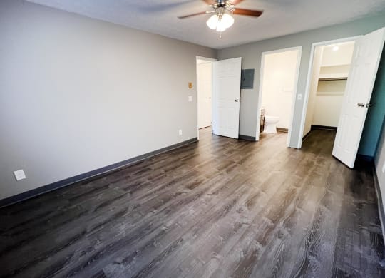 a bedroom with hardwood floors and a ceiling fan at Quail Meadow Apartments, Ohio