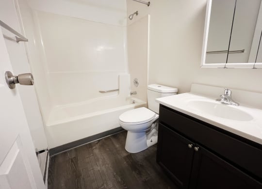 a bathroom with a toilet sink and bathtub at Quail Meadow Apartments, Cincinnati, 45240