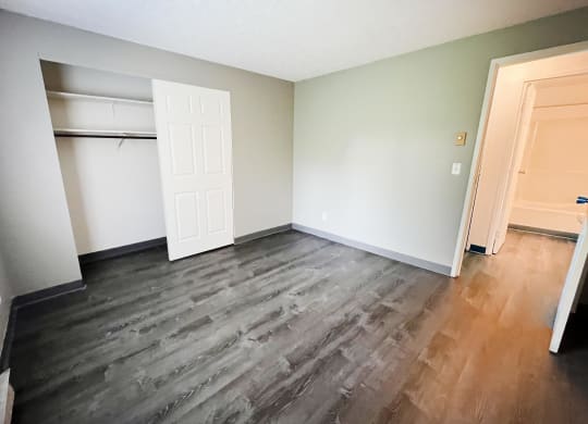 a bedroom with hardwood flooring and a closet at Quail Meadow Apartments, Cincinnati, Ohio