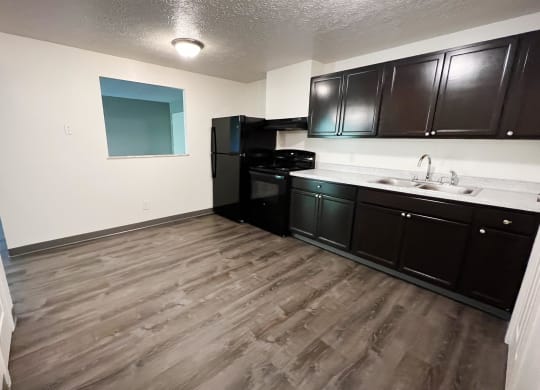 a kitchen with black cabinets and white countertops at Quail Meadow Apartments, Cincinnati, OH, 45240