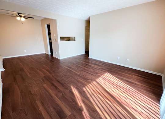 an empty living room with wood flooring in an empty house at Concord Woods Apartments, Milford, 45150