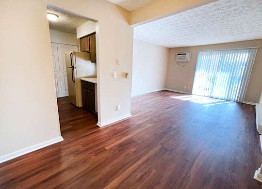 an empty living room with wood flooring in an apartment at Concord Woods Apartments, Milford, OH 45150