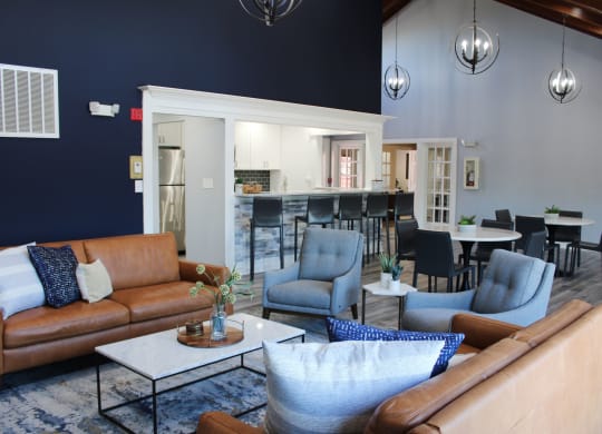 a living room with couches and chairs and a kitchen at Steeplechase Apartments, Loveland, 45140