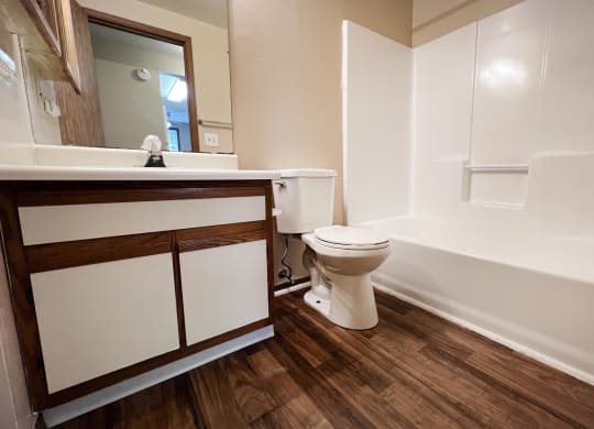a bathroom with a toilet sink and bathtub  at Woodhills Apartments, Ohio, 45449
