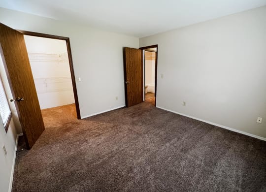 a bedroom with a carpeted floor  at Woodhills Apartments, West Carrollton