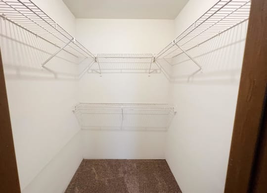 a spacious walk in closet with white walls  at Woodhills Apartments, West Carrollton, OH, 45449