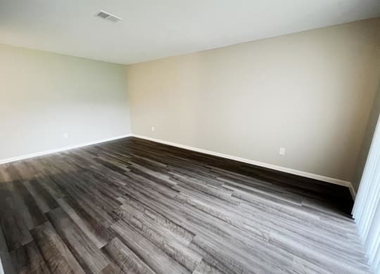 a bedroom with hardwood floors and white walls  at Timber Ridge Apartments, Cincinnati