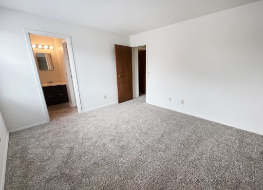 an empty bedroom with a carpeted floor  at Four Worlds Apartments, Ohio, 45231