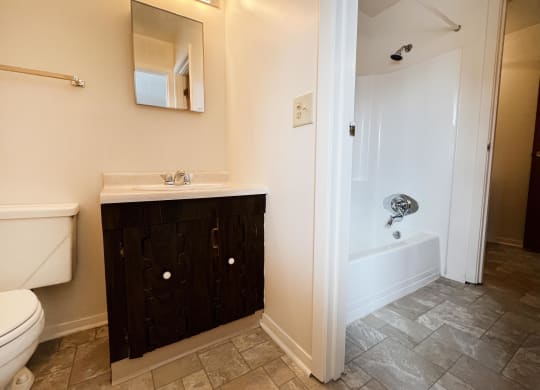 a bathroom with a toilet sink and bathtub  at Four Worlds Apartments, Cincinnati, OH