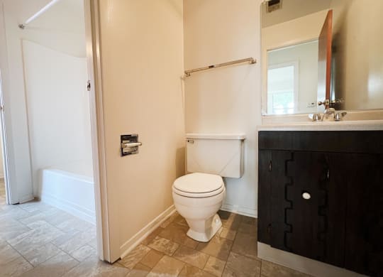 a bathroom with a toilet sink and bathtub  at Four Worlds Apartments, Cincinnati, 45231
