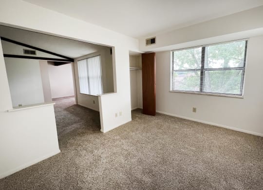 an empty room with a large window  at Four Worlds Apartments, Cincinnati, Ohio