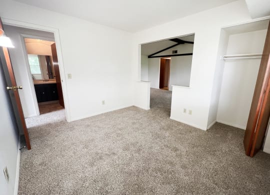 a bedroom with white walls and carpet  at Four Worlds Apartments, Ohio