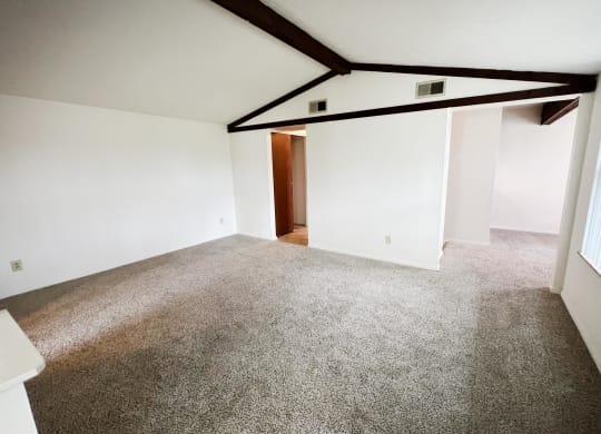 a bedroom with a carpeted floor and white walls  at Four Worlds Apartments, Cincinnati