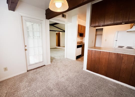 a living room with a white door and a kitchen in the background  at Four Worlds Apartments, Cincinnati, OH, 45231