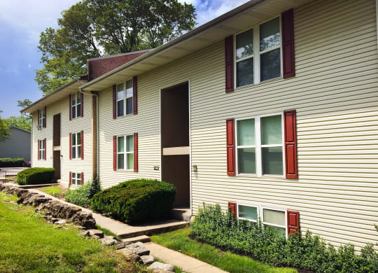 the side of a house with red windows and a sidewalk  at Timber Ridge Apartments, Cincinnati